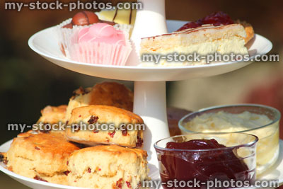Stock image of afternoon tea / cream tea, tiered cake stand, cakes, scones, jam, clotted cream