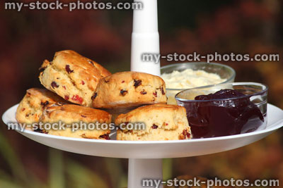 Stock image of afternoon tea / cream tea, tiered cake stand, cakes, scones, jam, clotted cream
