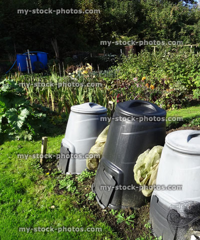Stock image of grey / black plastic garden compost bins, compost heap / converter, allotment / vegetable garden