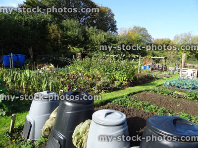 Stock image of grey / black plastic garden compost bins, compost heap / converter, allotment / vegetable garden