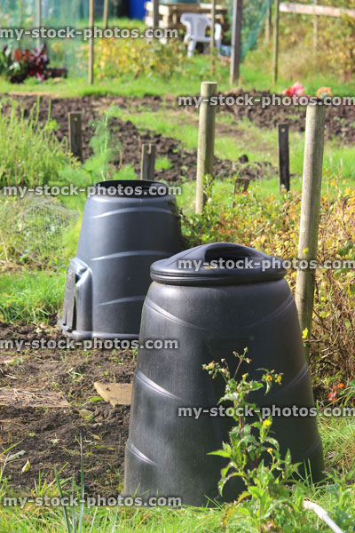 Stock image of plastic compost bins / converters, allotment vegetable garden waste, compost heaps