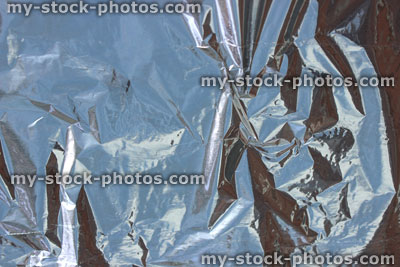 Stock image of crumpled aluminium foil background / wrinkled tin foil background