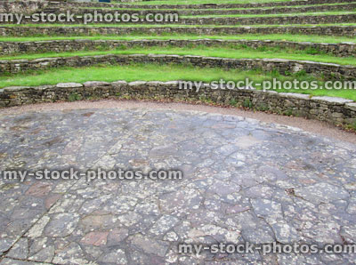 Stock image of curved stone and grass seats at outdoor amphitheatre