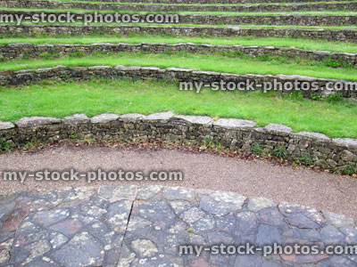 Stock image of curved stone and grass seats at outdoor amphitheatre