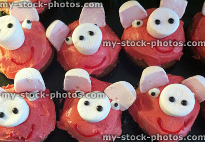 Stock image of home baking cupcake decoration ideas, pink pig cakes
