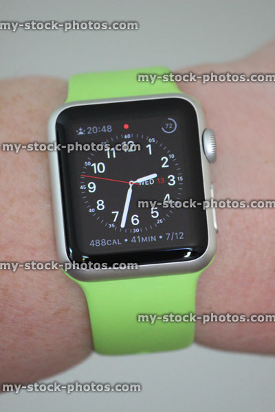 Stock image of Apple Watch Sport model, green strap, analogue clock face
