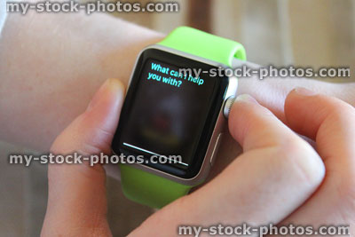Stock image of Apple Watch being used, Siri app clock face