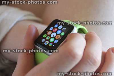 Stock image of buttons being pressed on Apple Watch apps screen