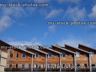 Stock image of contemporary architecture, houses with hardwood timber cladding, sloping roofs