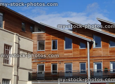 Stock image of modern houses with wooden cladding, timber clad contemporary architecture