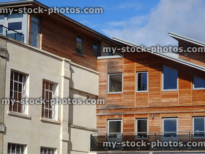 Stock image of historic building / modern houses, contrasting architecture, timber cladding, aluminium windows