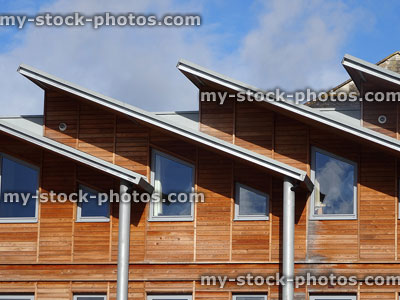 Stock image of contemporary / modern architecture, houses with sloping flat roofs, timber clad