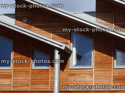 Stock image of modern houses, hardwood timber clad exteriors, sloping roofs, aluminium window frames