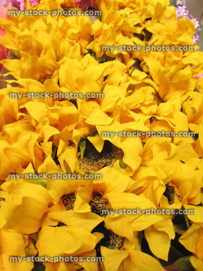 Stock image of plastic / silk sunflowers (Helianthus annuus) / artificial yellow flowers