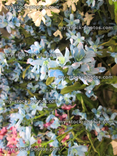 Stock image of pale blue artificial plastic / silk flowers / daisies