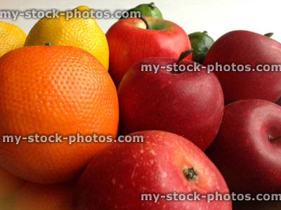 Stock image of artificial fruit, including plastic oranges and wax apples