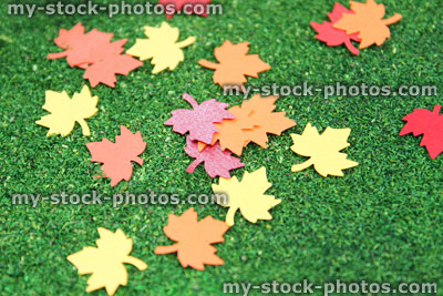 Stock image of red yellow orange autumn paper leaves, card maple leaf punch / cutter, fall colors
