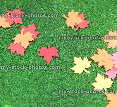 Stock image of red yellow orange autumn paper leaves, card maple leaf punch / cutter, fall colors