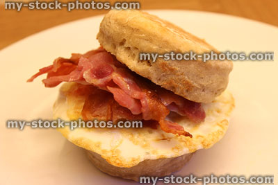 Stock image of bacon and egg breakfast muffin on white plate