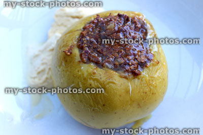 Stock image of baked apple, cooking apple stuffed with raisins, figs, nuts, sugar