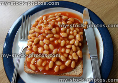 Stock image of baked beans on toast (wholemeal bread), with knife and fork