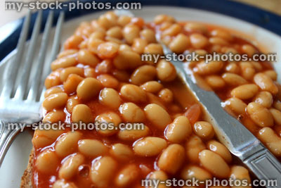 Stock image of baked beans on toast (wholemeal bread), with knife and fork