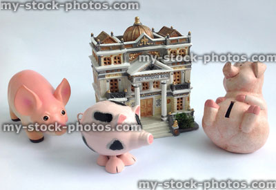 Stock image of model bank and a piggy banks