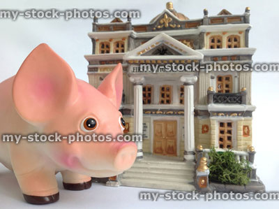 Stock image of model bank and a piggy bank