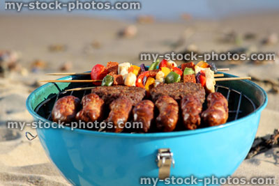 Stock image of beach barbecue, seaside BBQ, sausages, burgers, kebabs