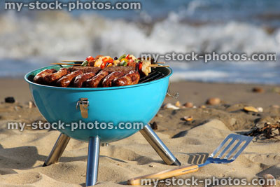 Stock image of beach barbecue, seaside BBQ, sausages, burgers, kebabs