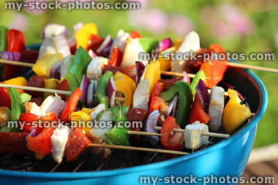 Stock image of charcoal barbecue / BBQ in garden, chicken shish kebabs