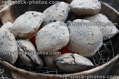Stock image of hot charcoal briquettes on barbecue / BBQ hot coals