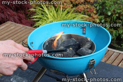 Stock image of lighting charcoal barbecue / BBQ lighter / flames on kettle barbecue coals