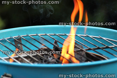 Stock image of lighting charcoal barbecue / BBQ / flames on kettle barbecue coals