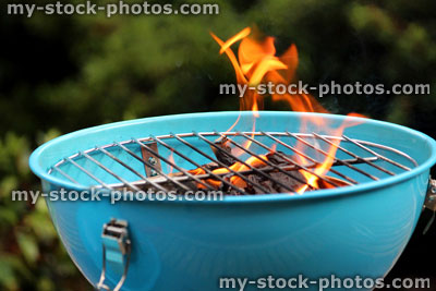 Stock image of lighting charcoal barbecue / BBQ / flames on kettle barbecue coals