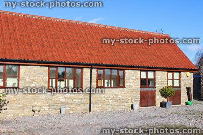 Stock image of old barn conversion house / bungalow, converted stables / outbuilding, gravel drive