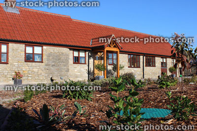 Stock image of old barn conversion house / bungalow, converted stables / outbuilding, hidden oil tank