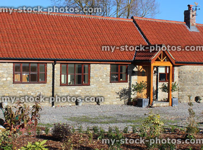 Stock image of old barn conversion house / bungalow, converted stables / outbuilding