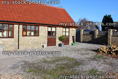 Stock image of old barn conversion house / bungalow, converted stables / outbuilding, gravel driveway