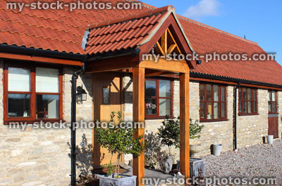 Stock image of barn conversion house / bungalow, converted stables / outbuildings, timber, wooden porch (open porch)