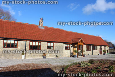 Stock image of old barn conversion house / bungalow, converted stables / outbuilding, front garden