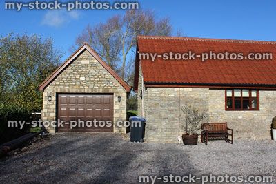 Stock image of detached garage building, barn conversion house / bungalow, converted stables / wheelie bins