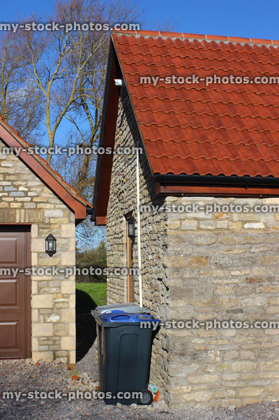 Stock image of detached garage building, barn conversion house / bungalow, wheelie bins / rubbish bins / recycling dustbins