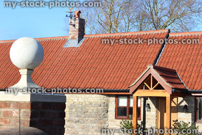 Stock image of red brick gate post, stone ball finial / pier cap, barn conversion bungalow, open porch
