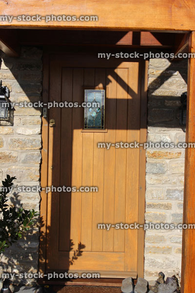 Stock image of gable design wooden open porch and front door / doorstep, cobblestone bricks