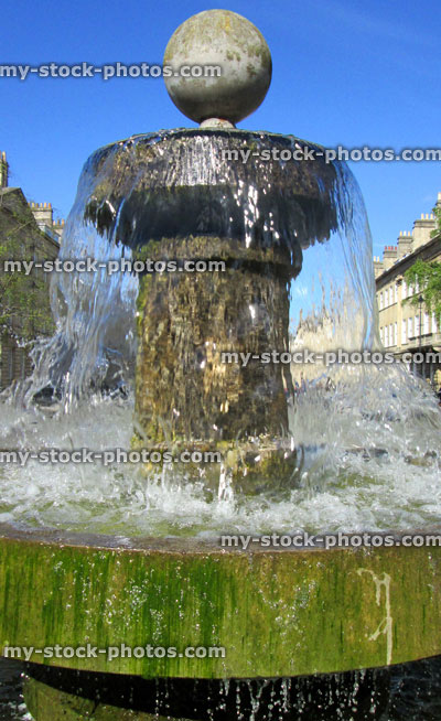 Stock image of photo of old fountain with cascading sparkling water in sunshine