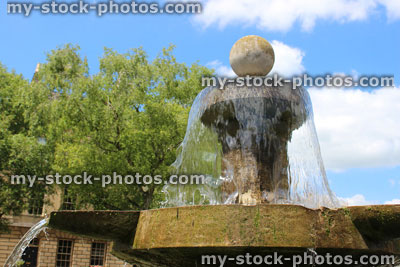 Stock image of old Bath stone fountain with cascading sparkling water in sunshine