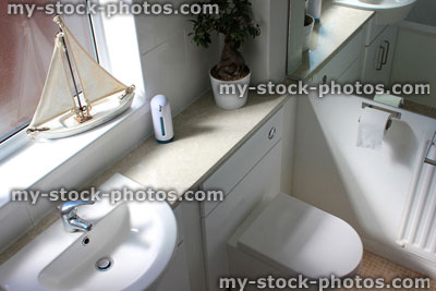 Stock image of white bathroom suite, sink, mixer tap, contemporary toilet