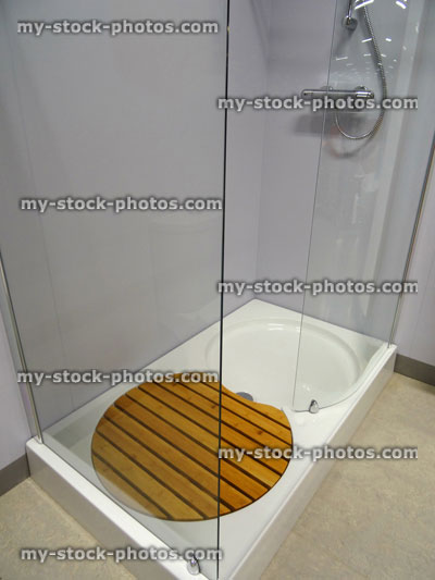 Stock image of modern bathroom, glass shower enclosure, white shower tray