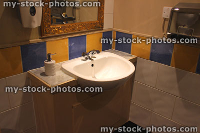 Stock image of white basin in toilet / bathroom with colourful tiles
